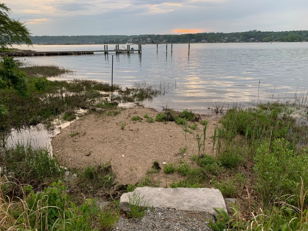 Gravel dumped to create a "beach," and stone added at end of driveway